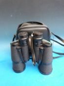 A cased pair of Tasco 10 x 50 binoculars