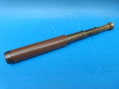 A brass and leather three draw telescope marked Broadhurst Clarkson & Co Ltd, 63 Farringdon Rd,