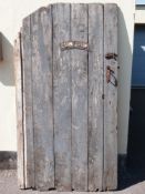 A vintage planked wooden door with fittings,