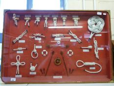 A large display case displaying a range of nautical knots by G C Wills