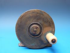 A vintage brass fishing reel by W.J.