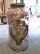 A large glass apothecary jar with gilt label 