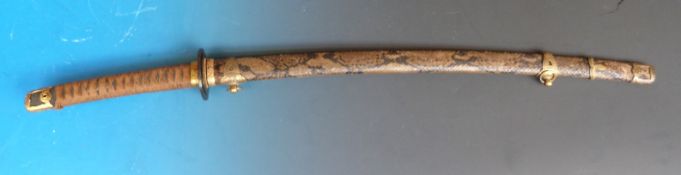A Kaigunto signed Japanese Naval sword in cobra skin sheath,
