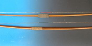 A pair of yew wood long bows,
