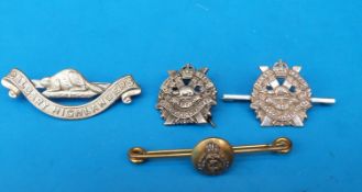 Two white metal regimental badges; one marked sterling,