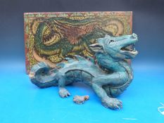 A pottery model of a dragon together with a plaque with dragon decoration