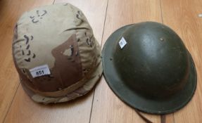 An American military helmet with desert camouflage cover,