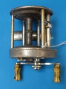 A Pflueger Supreme USA made multiplier fishing reel with twin marbled handles and patent numbers