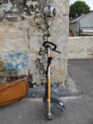 A Ryobi petrol strimmer