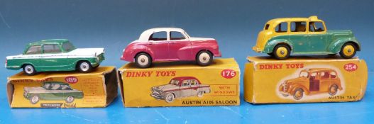 Three Dinky Toys diecast model cars, Austin A105 saloon 176, Triumph Herald 189 and Austin taxi 254,