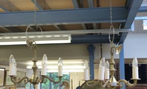 A pair of gilt five-branch light fittings and one similar