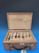 A collection of over 40 fishing lures mainly minnows set in a wooden lure box together with a