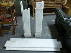 A Gothic-style white marble fireplace and hearth