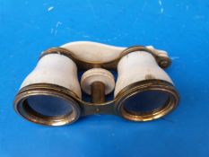 A pair of gilt and ivory opera glasses inscribed Woodward, Clements Inn Passage,