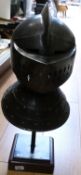 A replica medieval helmet on a purpose-built stand