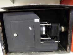 A large cased electric magic lantern by Triumph with adjustable lens,