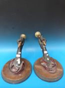 A pair of 19thC wall-mounted Blackamore-style light fittings formed as hands holding brass candle