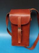 A leather curved gun magazine pouch