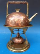A copper and brass Vienna secession style spirit kettle on stand with fouled anchor mark to