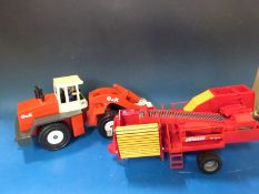 A collection of large scale farm and construction vehicles and sets,
