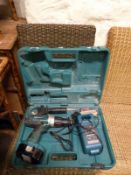 A Makita 8444D power drill with battery and charger in case
