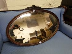 An oval mahogany framed mirror