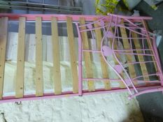 A pink bed frame with slats