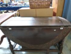 An 18th/19thC oak peg jointed drop leaf table with carved decoration (H72 x W120)