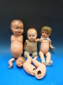 A collection of dolls and parts including a GE German doll and a doll with straw body and bisque