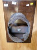 A German WW2 SS helmet and badge mounted on a wooden base having inscription relating to the helmet