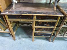 An oriental bamboo and lacquer desk with four drawers to one side and single door above kneehole