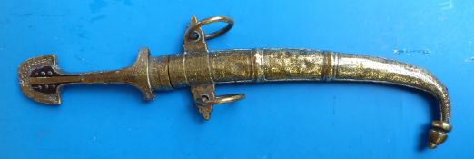 An Eastern style brass dagger in brass sheaf