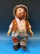 A Steiff hedgehog dressed in full outfit with original label (27cm tall)