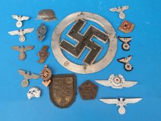 A quantity of WW2 Nazi German badges and insignia including cap badges together with an aluminium