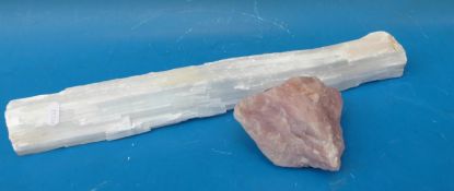 A very large selenite wand together with a rose quartz boulder