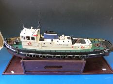A radio controlled kit built tug boat together with barge