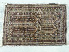 An Afghan Baluch rug on a predominantly wine red ground (150 x 95cm)