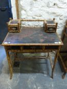 An oriental bamboo and lacquer side table or desk with two small drawers to top and single drawer