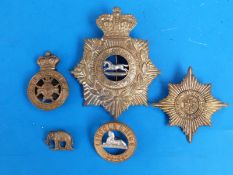 A collection of Victorian badges including home service helmet plate to the West Yorkshire regiment,
