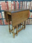 A light oak drop-leaf table