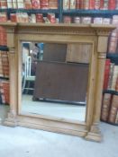 A pine wall mirror with half-column decoration and dentil moulding,