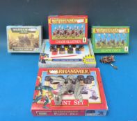 A selection of Warhammer figures and two paint sets