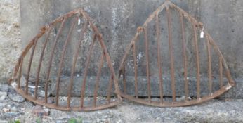 Two vintage iron corner hay racks