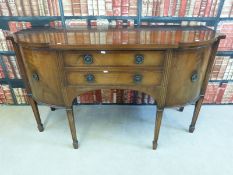 A reproduction mahogany sideboard with two central drawers flanked by cupboards (W152 x D60 x