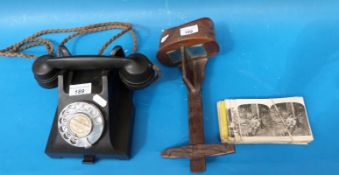 A vintage bakelite telephone and a stereoscopic viewer with slides including Chicago and New York