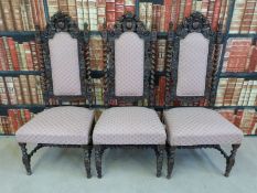 Three carved oak framed upholstered dining chairs