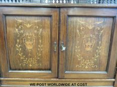 An ornate Edwardian mahogany and rosewood sideboard with inlaid detail,