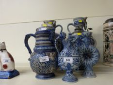A pair of Mettlach style Bavarian embossed jugs/vases together with five others, one lidded,
