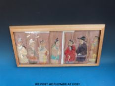 Seven 18thC Chinese stumpwork embroideries all of Chinese men, in light wood frame.