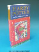 'Harry Potter and the Philosopher's Stone' with facsimile Rowling signature on the first page.